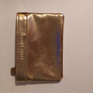 VGUC. Bobby Brown gold zip top card or change purse pouch.